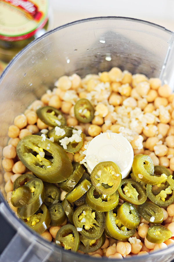 Canned chickpeas, sliced jalapenos, and minced garlic in a Cuisinart food processor