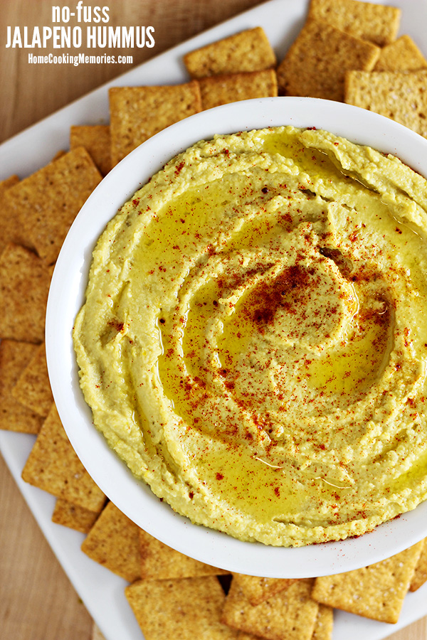 No-Fuss Jalapeno Hummus in a white bowl, served with Wheat Thin crackers.