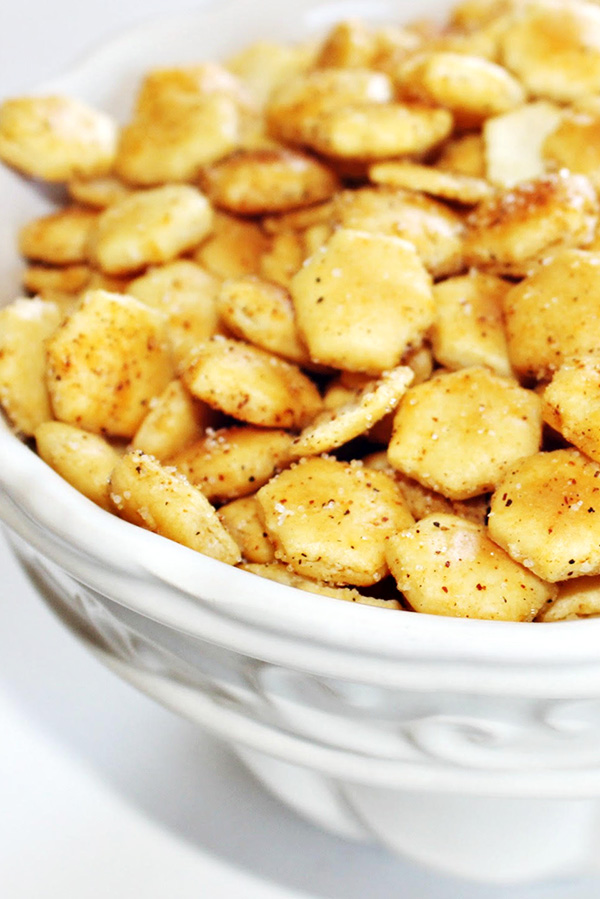 Close up of oyster crackers seasoned with Tony Chachere's Original Creole Seasoning, served in a while bowl