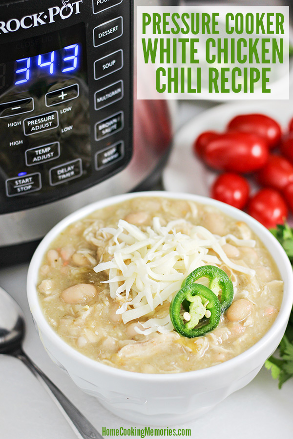 Bowl of White Chicken Chili topped with shredded cheese and sliced jalapenos with the Crock-Pot Express Crock Multi-Cooker in background