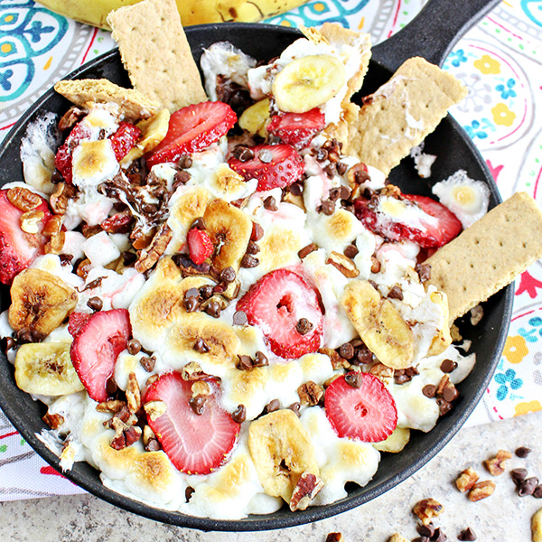 Banana Split Smores Dip Recipe served in a cast iron skillet with graham cracker dippers