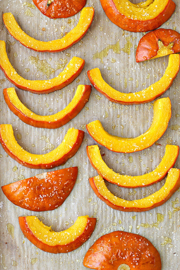 Sliced of baked pumpkin that have been seasoned with salt and olive oil