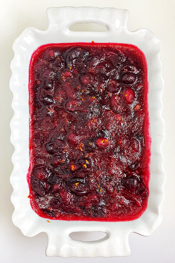 Homemade cranberry sauce with orange zest, served in a small white serving dish