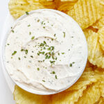 Plate of potato chips with a bowl of homemade onion dip