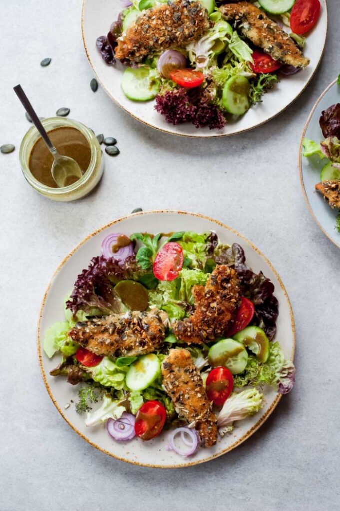 Change up your salad game with Pumpkin Seed Crusted Chicken! It adds an extra crunch and gives it a nutty flavor! 