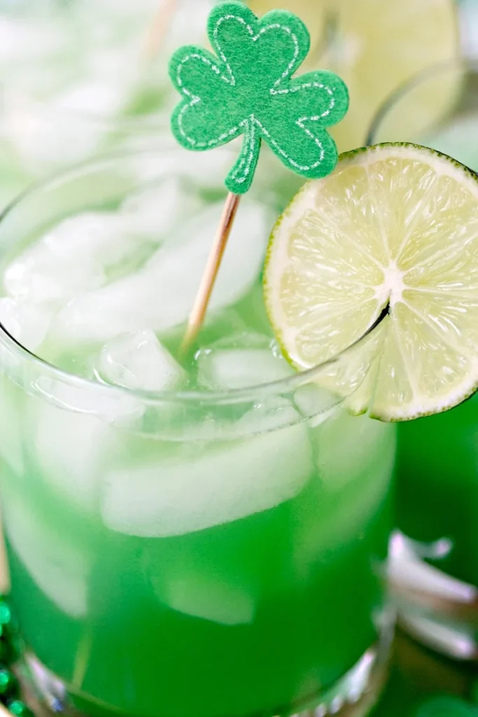 Shamrock Sour Cocktail in a short glass cup with a lime slice on the rim.