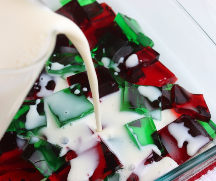 Pour the milk and unflavored gelatin mixture over the jello squares.