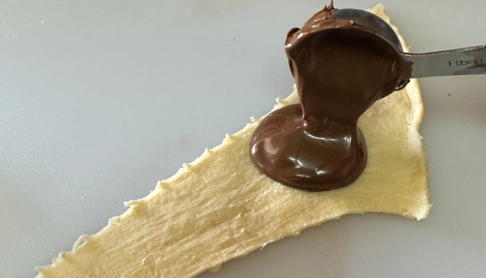 Lay out the crescent dough and add the tablespoon of nutella. You will spread it on the dough.
