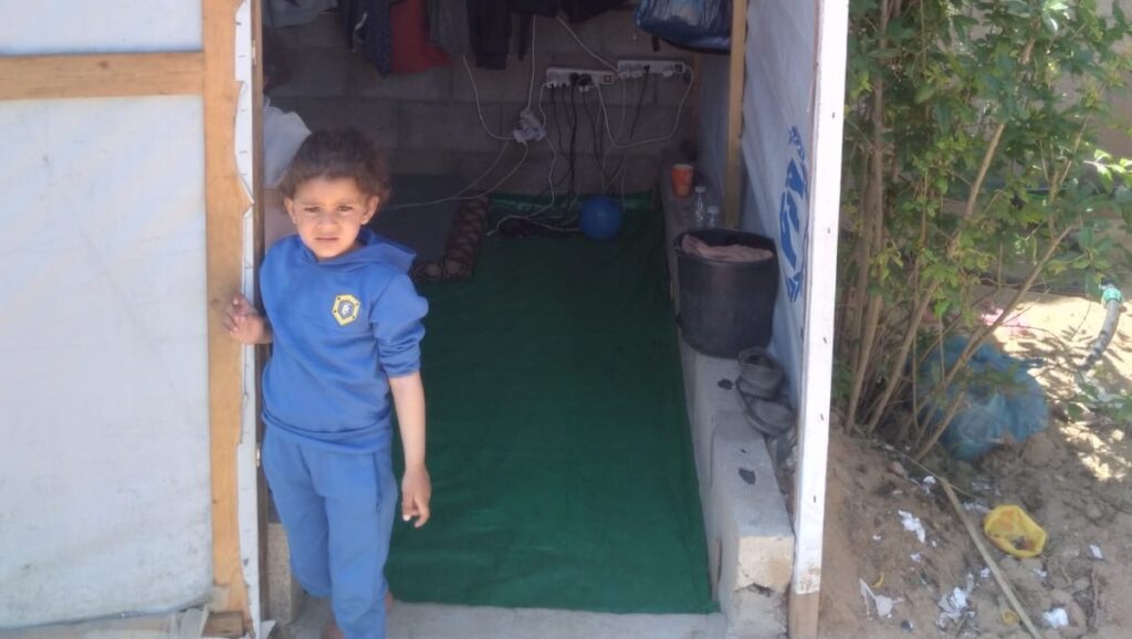 A family in Gaza have to live in a tent because they have been forced to leave their home. 